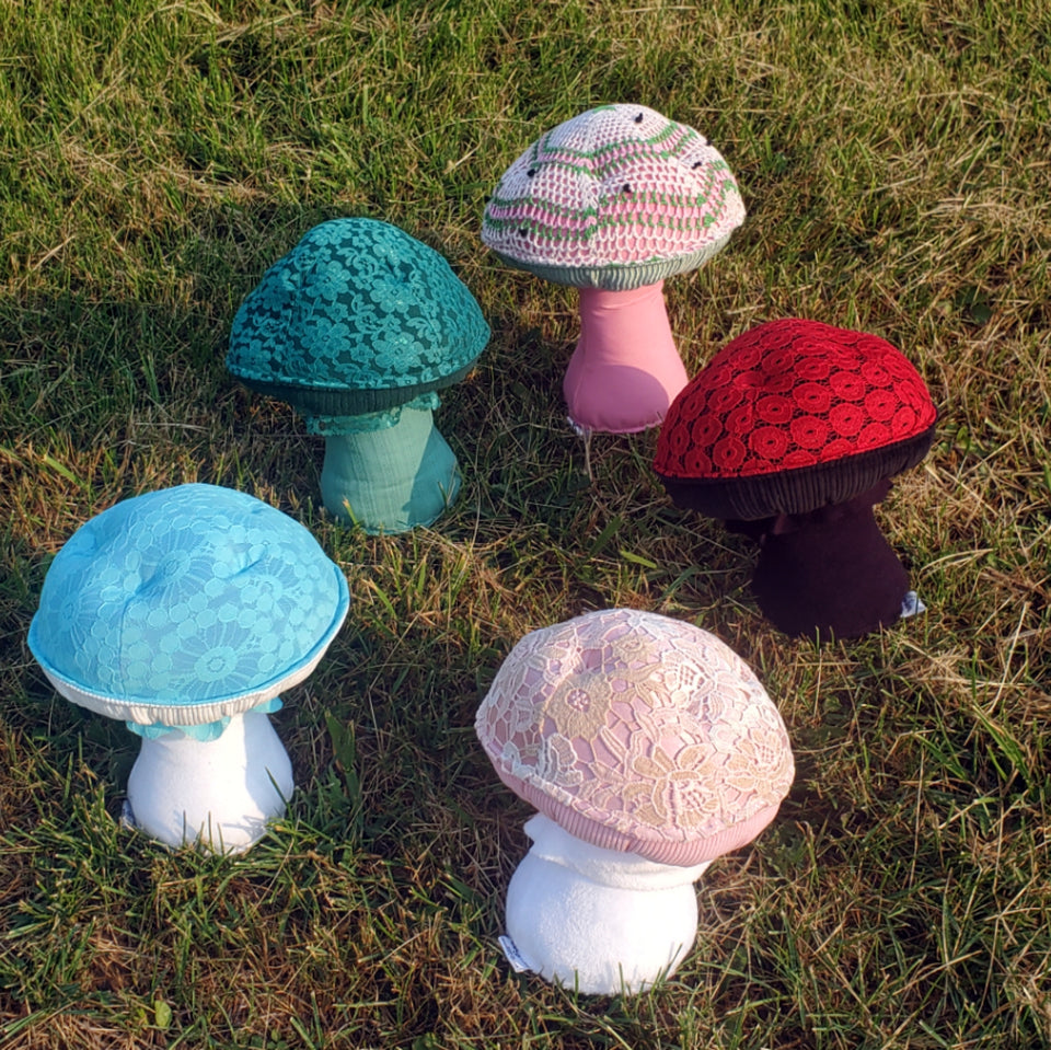 category lace plushrooms. five mushroom stuffies in a circle on the grass
